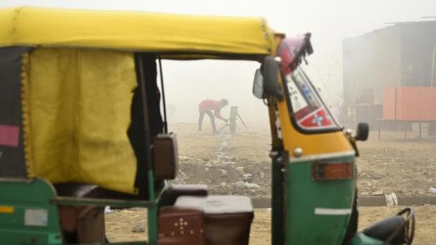 A youth washes his hands using water from a hand pump next to a parked auto rickshaw in the morning fog in Greater Noida, Uttar Pradesh. (R S Iyer / AP) A youth washes his hands using water from a hand pump next to a parked auto rickshaw in the morning fog in Greater Noida, Uttar Pradesh. (R S Iyer / AP)