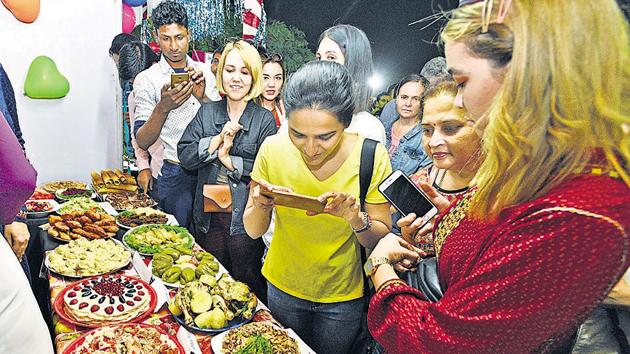 Visitors at the food festival at Savitribai Phule Pune University on Tuesday. (Left) A Mauritius delight and a fish dish from Mozambique seen displayed. (Pratham Gokhale/HT Photo) Visitors at the food festival at Savitribai Phule Pune University on Tuesday. (Left) A Mauritius delight and a fish dish from Mozambique seen displayed. (Pratham Gokhale/HT Photo)
