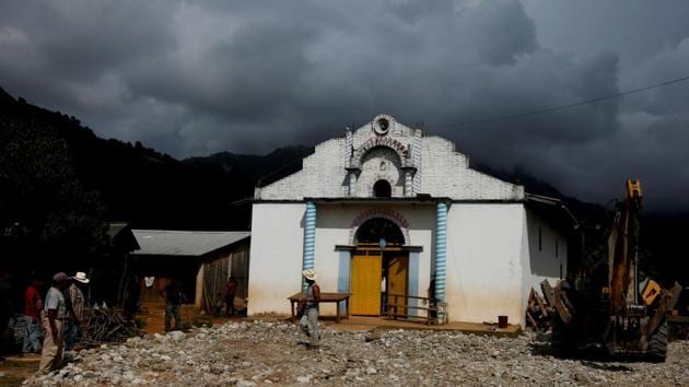 A man walks in front of a local church of Santa Cruz Yucucani. For now, several hours journey from the nearest hospitals or schools, Juquila Yucucani’s poppy farmers say they have two choices to make a living: sneak illegally into the United States, or grow poppies. (Carlos Jasso / REUTERS)