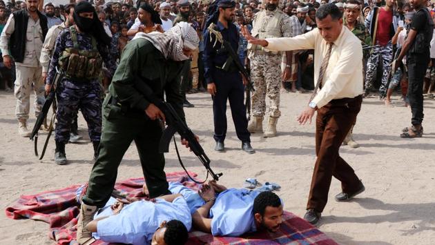 A police officer prepares for the execution of Wadah Refat, 28, and Mohamed Khaled, 31, who were convicted of raping a twelve-year-old boy in Aden, Yemen. (Fawaz Salman / REUTERS)