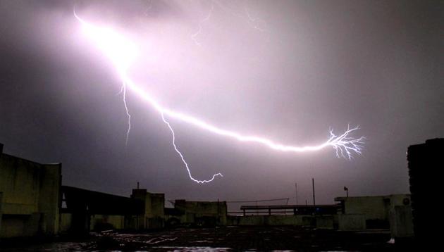 A lightning is seen during a storm that dropped heavy rains in Noida. (HT Photo) A lightning is seen during a storm that dropped heavy rains in Noida. (HT Photo)
