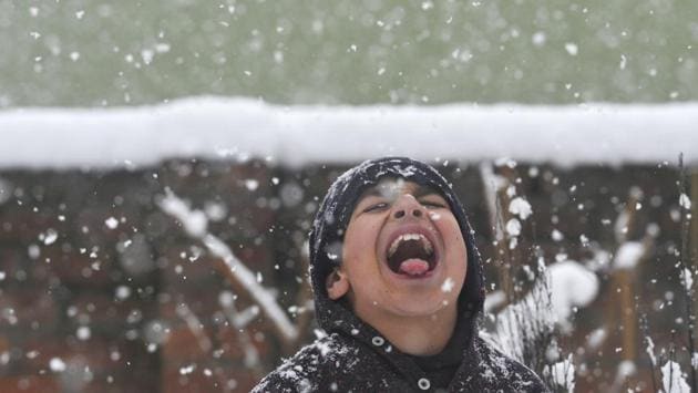 A boy tries to catch snowflakes during fresh snowfall in Srinagar, Jammu and Kashmir. (Waseem Andrabi / HT Photo) A boy tries to catch snowflakes during fresh snowfall in Srinagar, Jammu and Kashmir. (Waseem Andrabi / HT Photo)