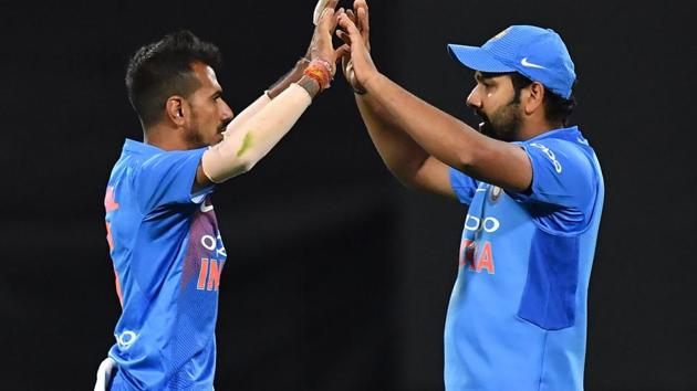 File image of Yuzvendra Chahal and Rohit Sharma celebrating a wicket. (AFP) File image of Yuzvendra Chahal and Rohit Sharma celebrating a wicket. (AFP)