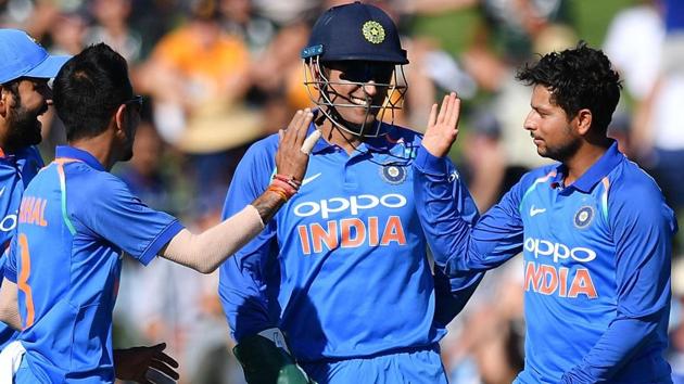 India's Kuldeep Yadav (R), Yuzvendra Chahal (front L) and wicket-keeper Mahendra Singh Dhoni (C).(AFP)