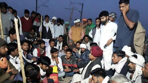 Gujjar leader K S Bainsla and his supporters sit on tracks at Malarna railway station in Sawai Madhopur in Rajasthan on Friday. (HT PHOTO) Gujjar leader K S Bainsla and his supporters sit on tracks at Malarna railway station in Sawai Madhopur in Rajasthan on Friday. (HT PHOTO)