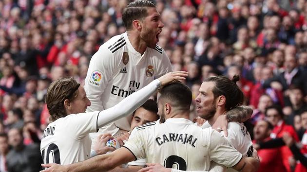 Real Madrid's Gareth Bale, right, celebrates with team mates after scoring his side's third goal. (AP) Real Madrid's Gareth Bale, right, celebrates with team mates after scoring his side's third goal. (AP)
