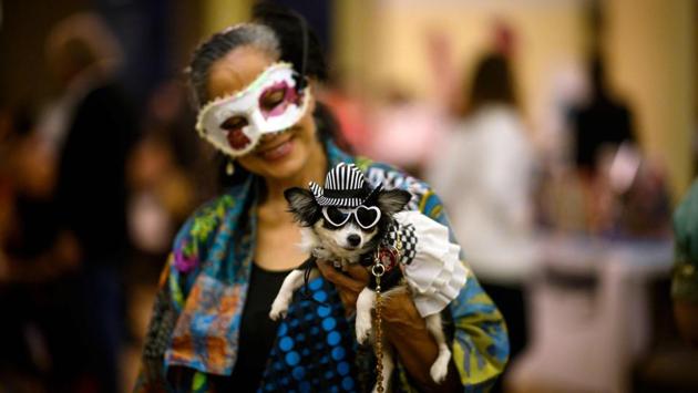 A participant holds her dog backstage at the 16th annual New York Pet Fashion Show. (Johannes Eisele / AFP)