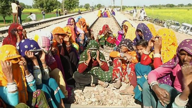 Members of Gujjar community sitting on railway track in Maksudanpura of Sawai Madhopur in protest as part of reservation movement.(ANI)