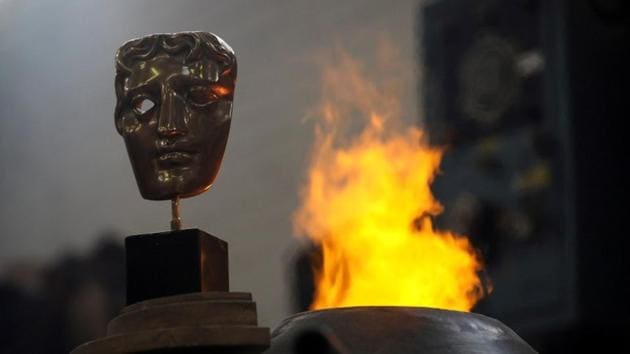 A completed British Academy of Film and Television Awards (BAFTA) mask is placed next to a furnace to be photographed at a foundry in west London.(REUTERS)