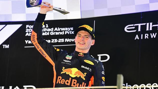 Red Bull's Dutch driver Max Verstappen (3rd) celebrates on the podium after the Abu Dhabi Formula One Grand Prix at the Yas Marina circuit on November 25, 2018, in Abu Dhabi(AFP)