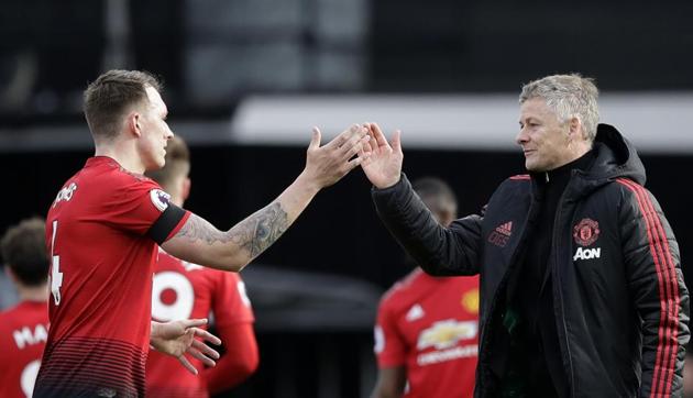 Manchester United caretaker head coach Ole Gunnar Solskjaer, right, and Manchester United's Phil Jones celebrate at the end of the English Premier League soccer match between Fulham and Manchester United (AP) Manchester United caretaker head coach Ole Gunnar Solskjaer, right, and Manchester United's Phil Jones celebrate at the end of the English Premier League soccer match between Fulham and Manchester United (AP)