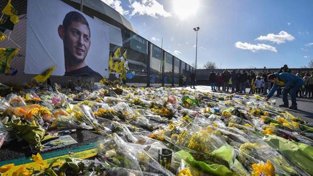 Yellow flowers are displayed in front of the portrait of Argentinian forward Emiliano Sala at the Beaujoire stadium in Nantes, on February 10.(AFP)