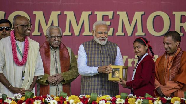 Prime Minister Narendra Modi receives a memento from a girl as UP Governor Ram Naik and Chief Minister Yogi Adityanath look on, during a programme to mark the serving of the 3rd billionth meal by the Akshaya Patra Foundation, in Vrindavan. Modi will also serve food to underprivileged schoolchildren at Vrindavan Chandrodaya Mandir campus. (PTI)