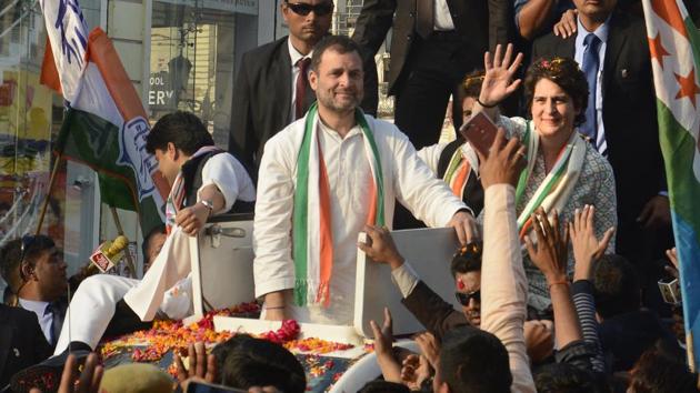 Congress party president Rahul Gandhi looks on as his sister Priyanka Gandhi Vadra waves at supporters during a rally in Lucknow on February 11.(AP Photo)