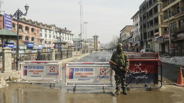 A paramilitary solider stands guard during a strike called by separatists to mark the 35th death anniversary of JKLF founder Mohammad Maqbool Bhat, who was hanged on this day in 1984 in Delhi’s Tihar jail. Shops and other business establishments remained closed while public transport was off roads due to the shutdown, officials said. (Waseem Andrabi / HT Photo)