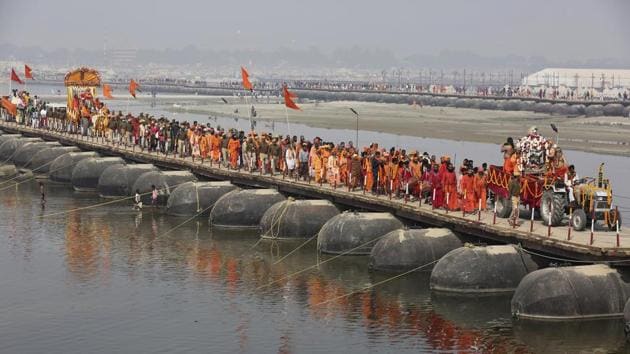 Men return after taking ritualistic dip at Sangam, the confluence of three sacred rivers the Yamuna, the Ganges and the mythical Saraswati, during the Kumbh Mela or the Pitcher Festival, in Prayagraj on February 11.(AP File Photo)