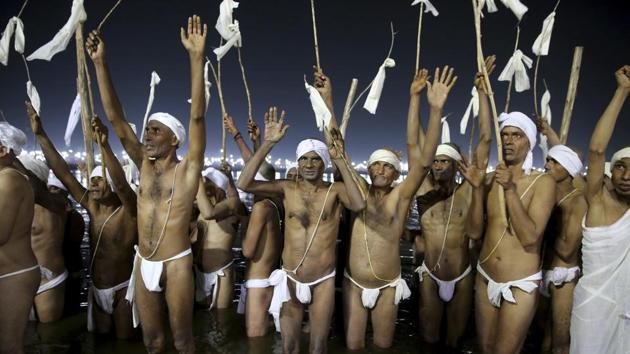 After they are ordained, the Naga Sadhus must remain partially or fully naked for the rest of their lives, sleep on the ground, limit themselves to one meal a day, obey their leaders and gurus and protect the Hindu religious traditions. (Rajesh Kumar Singh / AP)