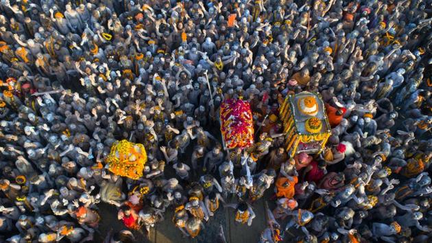 On so-called ‘Shahi snan’ or royal bathing days, the Naga Sadhus lead the 13 monastic orders’ processions — on garlanded horses, elephants and tractors — through the festival grounds and into the river, armed with tridents and swords. (Rajesh Kumar Singh / AP)