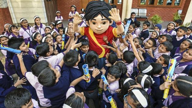 A human mascot of cartoon character Shiva shares a light moment with students on the premises of RN Shah English Medium Primary School, Kasba peth, in Pune on Monday. The fun activity was organised by the school to reduce exam stress for children. (Pratham Gokhale/HT Photo) 