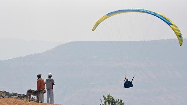 Sang Oh, a professional paraglider, was participating in the third edition of a six-day international paragliding competition, which has drawn 130 gliders from 23 countries. (Pratham Gokhale/HT Photo) Sang Oh, a professional paraglider, was participating in the third edition of a six-day international paragliding competition, which has drawn 130 gliders from 23 countries. (Pratham Gokhale/HT Photo)