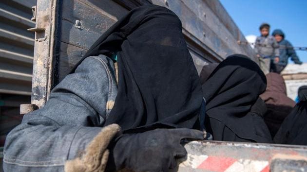 Women and children displaced from Deir Ezzor sit in the back of a truck after they fled the Islamic State (IS) holdout near Baghouz, eastern Syria. Among the fleeing were those born in a “state” that no longer exists, most to fathers who are dead and mothers whose countries don’t want them back. These are the children pouring out of Baghouz. (Fadel Senna / AFP) Women and children displaced from Deir Ezzor sit in the back of a truck after they fled the Islamic State (IS) holdout near Baghouz, eastern Syria. Among the fleeing were those born in a “state” that no longer exists, most to fathers who are dead and mothers whose countries don’t want them back. These are the children pouring out of Baghouz. (Fadel Senna / AFP)
