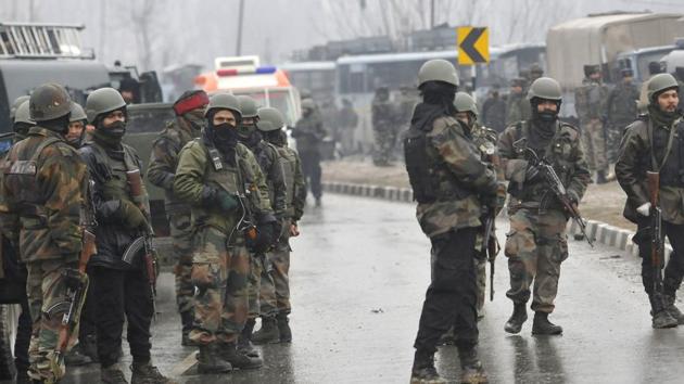Secuirty forces near the damaged vehicles at Lethpora on the Jammu-Srinagar highway.(HT Photo/ Waseem Andrabi) Secuirty forces near the damaged vehicles at Lethpora on the Jammu-Srinagar highway.(HT Photo/ Waseem Andrabi)