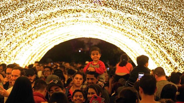 People enjoy a light show during the festivities for the 477th anniversary of the foundation of Guadalajara, Mexico. The city began the anniversary celebrations on February 14 with the largest robotic light festival in Latin America. (Ulises Ruiz / AFP)
