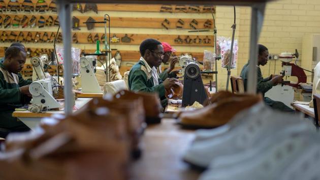 Employees seen working on the production line. Hammered by hyperinflation 10 years ago, Zimbabwe is again being roiled by a currency crisis, government mismanagement and fuel shortages. Many businesses have folded and investors have fled over the last 20 years, but the Courteney Boot company is rushing to keep up with orders. (Zinyange Auntony / AFP)