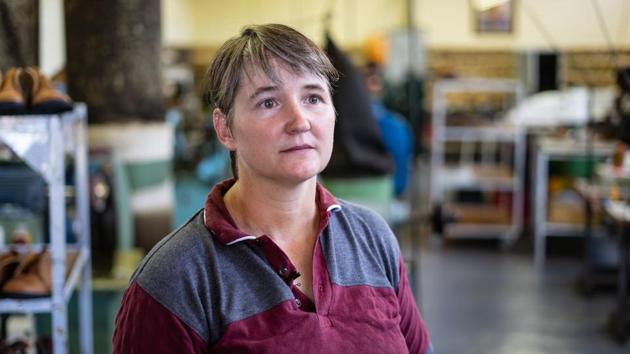 Courteney boot company's manager Helen Emerick stands at the shoe factory. “We asked our current long-serving staff to select the new ones,” said manager Helen Emerick in the factory amid smells of leather, hot rubber, glue and machine oil. “They know exactly what skills are needed and how much hard work it takes. They want the company to grow and we want a happy team.” (Zinyange Auntony / AFP)