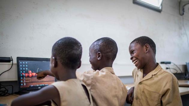 Schoolchildren from Avrankou-Houeze school attend a BloLab training in a container at Avrankou city hall, in Avrankou, south of Benin. Designed by BloLab, a non-profit group based in Benin’s largest city Cotonou, the 13-metre (43-foot) lorry trailer is powered by 12 solar panels and equipped with enough laptops to give rural students a chance to familiarise themselves with computers, which most families cannot afford. (Yanick Folly / AFP) Schoolchildren from Avrankou-Houeze school attend a BloLab training in a container at Avrankou city hall, in Avrankou, south of Benin. Designed by BloLab, a non-profit group based in Benin’s largest city Cotonou, the 13-metre (43-foot) lorry trailer is powered by 12 solar panels and equipped with enough laptops to give rural students a chance to familiarise themselves with computers, which most families cannot afford. (Yanick Folly / AFP)