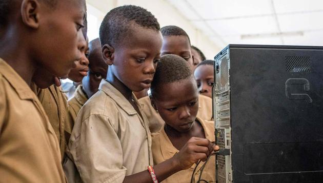 “When the teacher told us that we’d start having computer class again, I quickly finished my work because I was so happy,” said Ambroise, from eastern Benin’s Avrankou district. In his class of 48, only four pupils had even touched a computer before. Ambroise had used one at a photocopy shop, while the other three had a sibling who owned one. (Yanick Folly / AFP) “When the teacher told us that we’d start having computer class again, I quickly finished my work because I was so happy,” said Ambroise, from eastern Benin’s Avrankou district. In his class of 48, only four pupils had even touched a computer before. Ambroise had used one at a photocopy shop, while the other three had a sibling who owned one. (Yanick Folly / AFP)