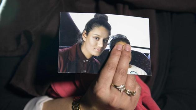 In this file photo taken on February 22, 2015, Renu Begum, eldest sister of missing British girl Shamima Begum, holds a picture of her sister while being interviewed by the media in central London.(AFP)