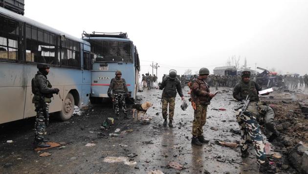 Soldiers stand at the attack site in Pulwama on Jammu-Srinagar highway. (Reuters photo) Soldiers stand at the attack site in Pulwama on Jammu-Srinagar highway. (Reuters photo)