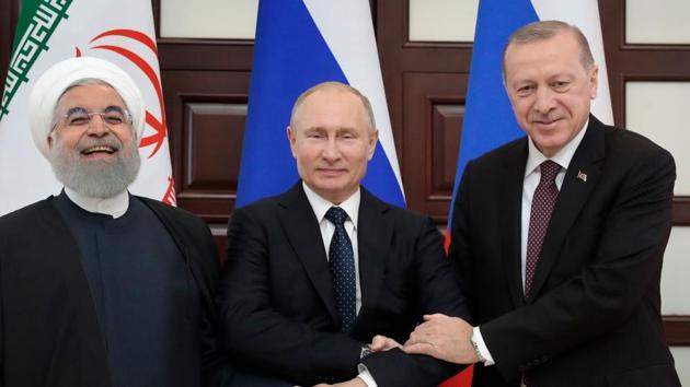 Russian President Vladimir Putin (C), Turkish President Recep Tayyip Erdogan (R) and Iranian President Hassan Rouhani pose prior to a trilateral meeting on Syria in the Black Sea resort of Sochi. (Sergei CHIRIKOV / AFP)