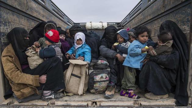 Woman and children from Deir Ezzor wait in the back of the truck as they fled the Islamic State (IS) holdout near Baghouz, eastern Syrian. (Fadel SENNA / AFP)
