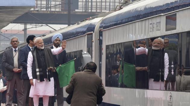Prime Minister Narendra Modi flags off Vande Bharat Express, India's first semi-high speed train, at New Delhi Railway Station, in New Delhi. The Vande Bharat Express is a all air-conditioned luxury train and will take around eight hours to travel between Delhi and Varanasi, halting at only two stations - Kanpur and Allahabad. (Sanjeev Verma / HT Photo)
