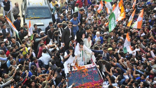 Congress president Rahul Gandhi, party general secretary in-charge of east UP Priyanka Gandhi and general secretary in-charge of west UP Jyotiraditya Scindia wave to the crowd during the road show from the Chaudhary Charan Singh airport to the Uttar Pradesh Congress Committee (UPCC) headquarters in Lucknow, Uttar Pradesh. (Deepak Gupta / HT Photo)