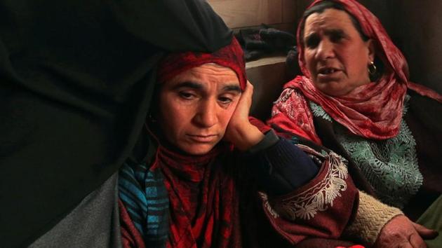 Fahmeeda (Left), mother of Adil Ahmad Dar, who claimed responsibility for the Pulwama terror attack, sits inside her home in Gundbagh village in south Kashmir's Pulwama district.(Reuters)