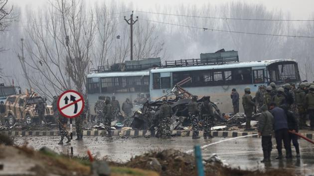Security forces seen near the damaged vehicles at Lethpora on the Jammu-Srinagar highway in the Pulwama district of Jammu and Kashmir. Forty CRPF jawans were killed and many others injured in an improvised explosive device (IED) blast. (Waseem Andrabi / HT Photo)