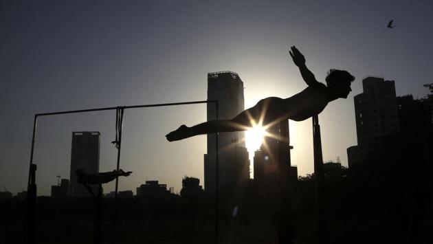 A player performs on a Mallakhamb pole during an early morning training session at Shivaji Park in Mumbai, Maharashtra. (Rafiq Maqbool / AP Photo)