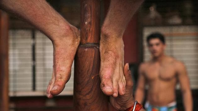 A trainer helps Alfie Meeson of Newcastle, England, on a mallakhamb pole. Participants from 15 countries, including the U.S. and Germany, will compete in the championship. (Rafiq Maqbool / AP Photo)