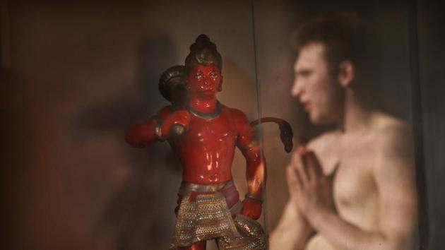 A player folds his hands in reverence near a statue of Hindu monkey-god Hanuman, a respected deity whose blessings are evoked after each Mallakhamb class, at the Shree Samartha Vyayam Mandir at Shivaji Park. (Rafiq Maqbool / AP Photo)