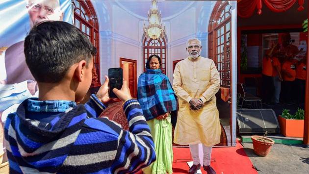 A woman poses with a life-size cardboard cut-out of Prime Minister Narendra Modi at Kumbh Mela festival, in Prayagraj, Uttar Pradesh. (Arun Sharma / PTI )