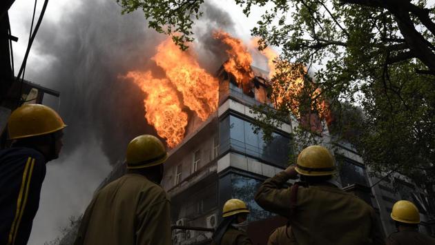 Fumes of smoke seen as firefighters try to douse the fire that broke out early morning in Archies Card Factory, at Naraina Industrial area, in New Delhi. (Sanchit Khanna / HT Photo)