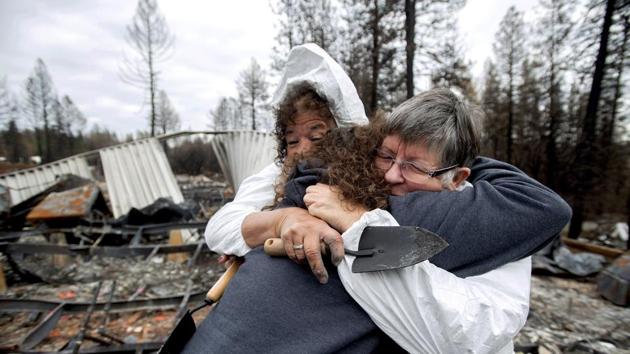 Carol Beall, right, hugs friends as they comb through the remains of her residence, destroyed by the Camp Fire, in Paradise, California. It was the first time that Beall, who lived in the the Ridgewood Mobile Home Park, returned to Paradise since fleeing the blaze in November 2018. (Noah Berger / AP Photo)