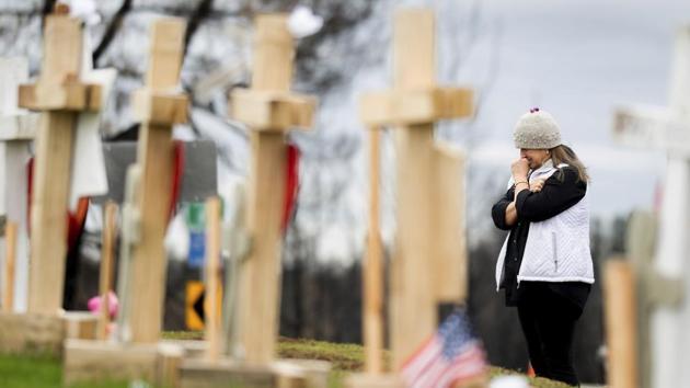 Joanie Ellison cries while visiting a memorial for Camp Fire victims in Paradise, Calif. Ellison, currently staying on her daughter's couch, hopes to re-settle in Paradise. Notwithstanding the rescue operations in Paradise, the place still appears like a ghost town, with the survivors latching on to the memories of their loved ones who lost their lives in the fire. (Noah Berger / AP Photo)