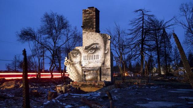 Another mural by artist Shane Grammer adorns the chimney of a residence leveled by the Camp Fire in Paradise. (Noah Berger / AP Photo)