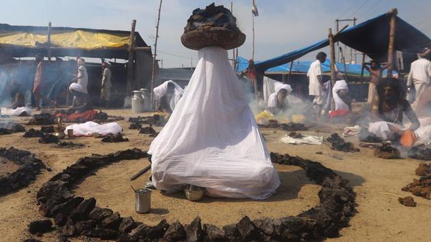 Sadhus or Hindu holy men offer prayers while sitting inside circles of burning "Upale" (or dried cow dung cakes) after taking a dip during the third "Shahi Snan" (grand bath) at "Kumbh Mela," in Prayagraj, Uttar Pradesh. (Jitendra Prakash / REUTERS)