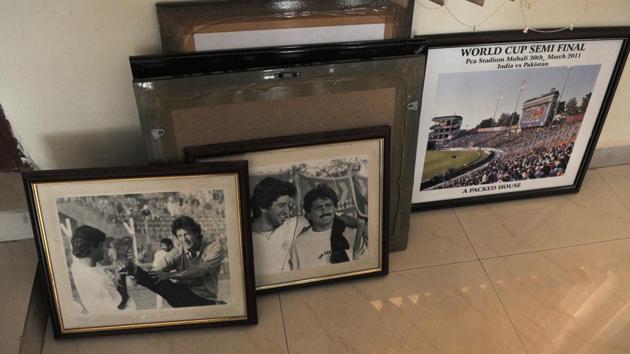 The frames, around a dozen in number, are official match pictures, including that of the crowd during the 2011 World Cup semifinal between the arch rivals, besides candid shots of players, including Pakistan PM Imran Khan and former pacer Wasim Akram.(Ravi Kumar/HT)