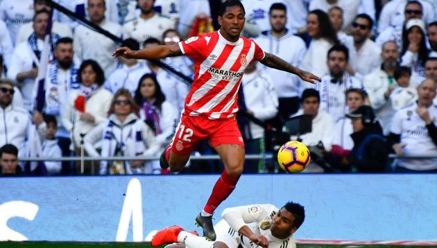 Girona's Brazilian midfielder Douglas Luiz jumps over Real Madrid's Brazilian midfielder Casemiro (bottom) during the Spanish League football match between Real Madrid and Girona at the Santiago Bernabeu stadium in Madrid on February 17, 2019(AFP)